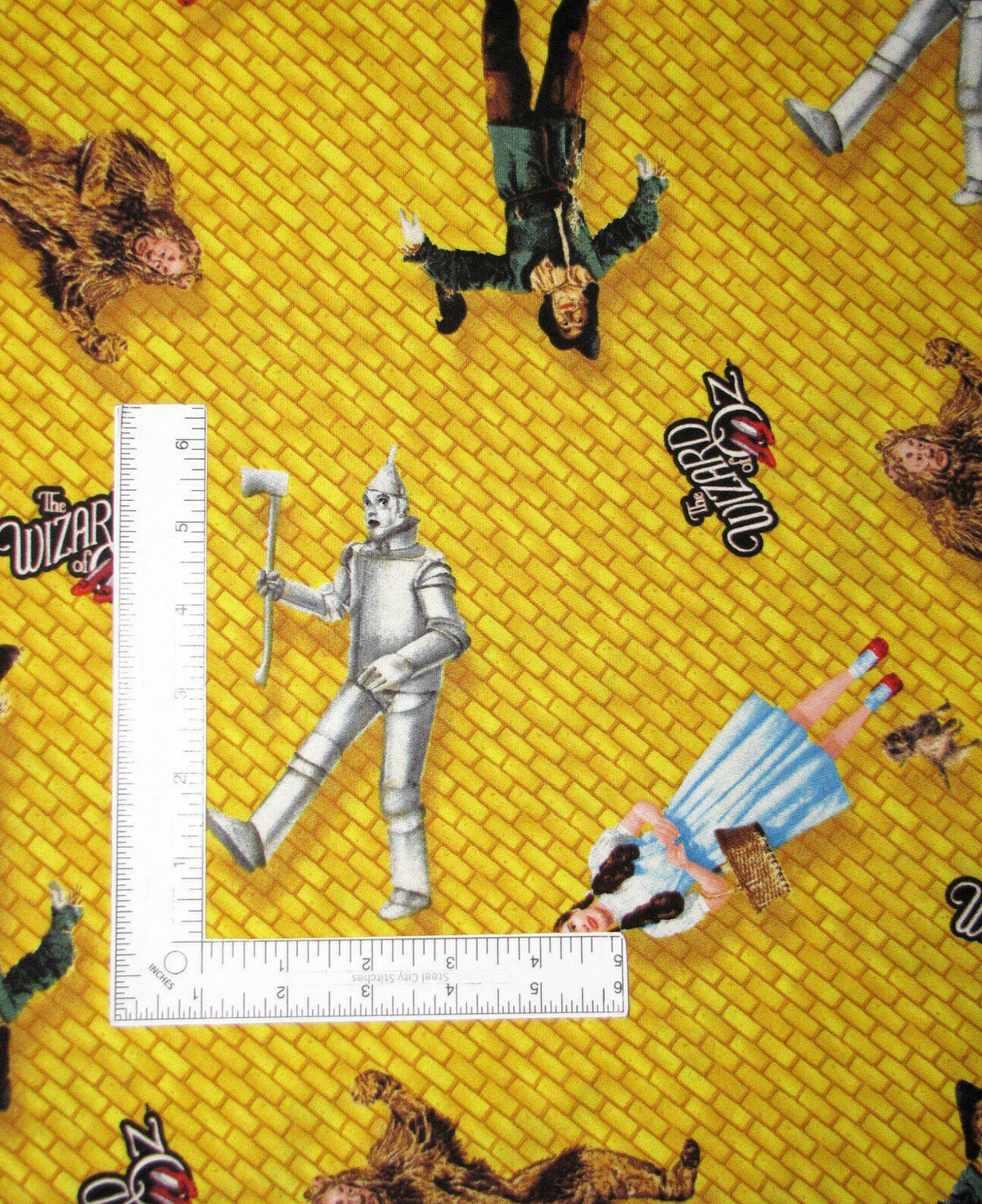 Wizard of Oz Characters Tossed on Yellow Brick Road Quilting Treasures Half Yard